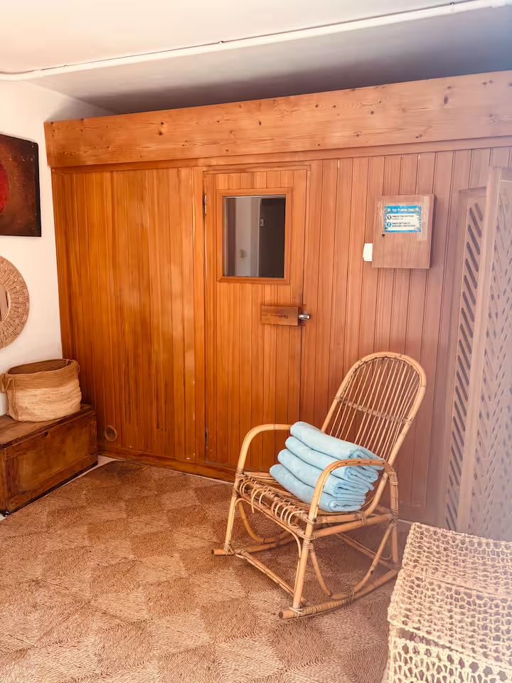 Cedar sauna with rattan rocking chair