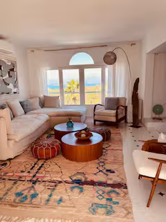 Living room with sea view through arched window