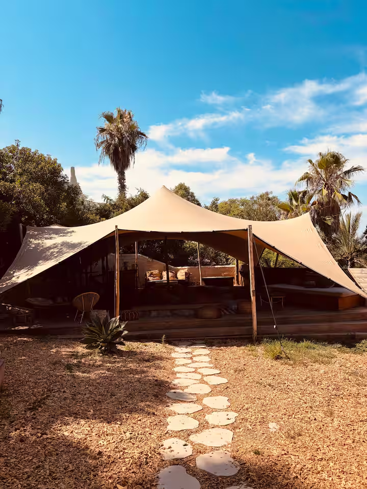 Shaded stretch-tent lounge in the garden